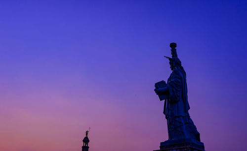 Low angle view of statue against sky during sunset