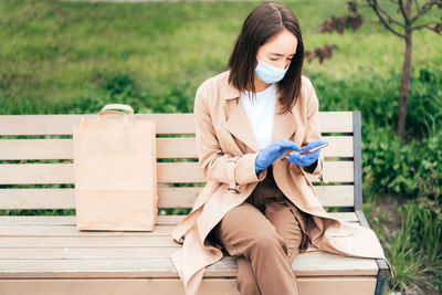 Young woman sitting on bench