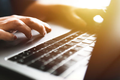 Cropped image of businesswoman using laptop