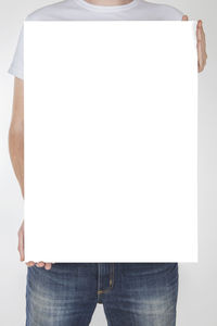 Close-up of hand holding paper against white background