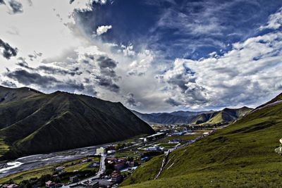 Scenic view of mountains against cloudy sky