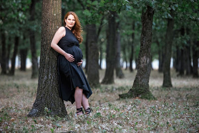 Full length portrait of woman in forest