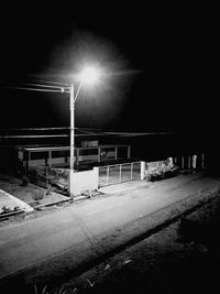 Illuminated street light in city at night