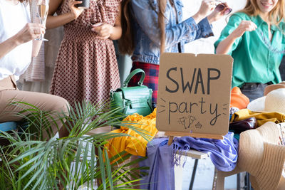 Midsection female friends shopping at market stall