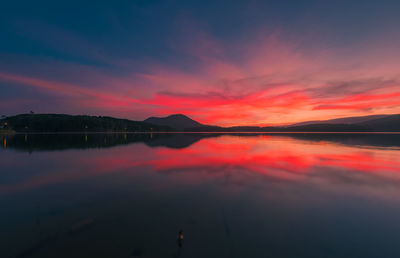 Scenic view of lake against romantic sky at sunset
