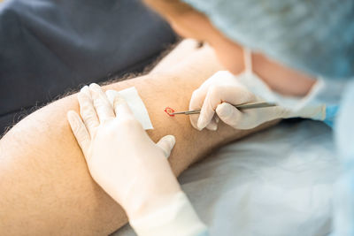 Midsection of doctor examining patient