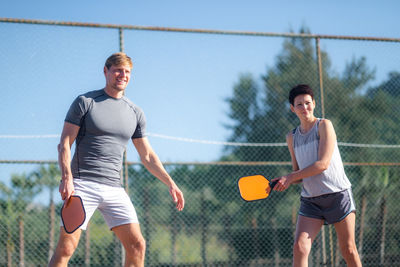 Rear view of woman playing tennis