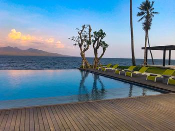 Scenic view of swimming pool by sea against sky