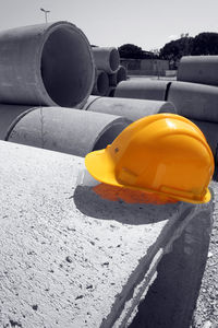 Close-up of yellow hat on car against sky