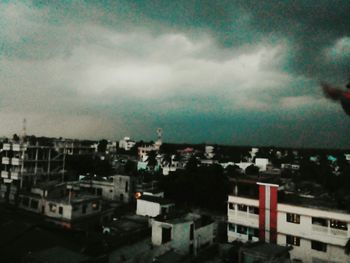 Buildings against cloudy sky