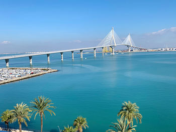 View of bridge over sea against blue sky