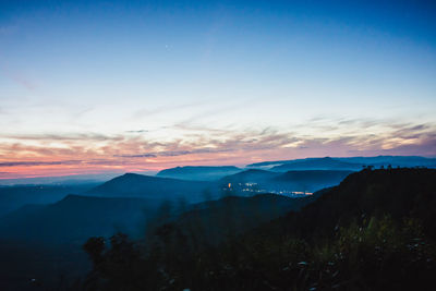 Scenic view of silhouette mountains against sky during sunset