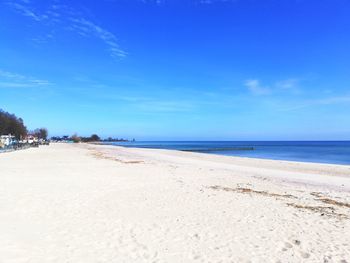 Scenic view of beach against blue sky