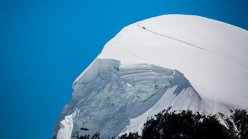 Low angle view of mountain against clear blue sky