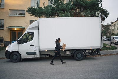 Side view of man standing on street in city