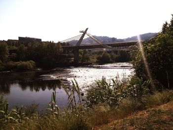 View of bridge over river against clear sky