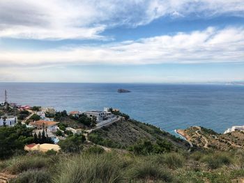 High angle view of sea and buildings against sky