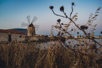 Traditional windmill on field against sky