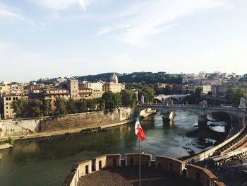 High angle view of river amidst cityscape against sky