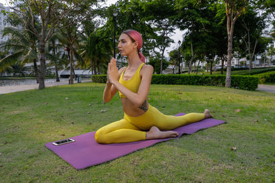 Young woman sitting on field