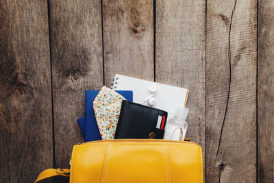 Flat lay travel concept with passports and black wallet, hand bag, face protective mask, sanitizer