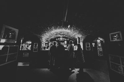 People standing in illuminated room