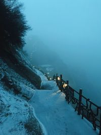 Snow covered pathway on mountain