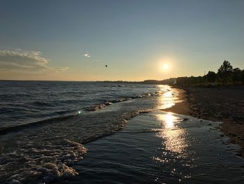 Scenic view of beach against sky during sunset