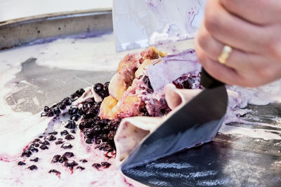 Cropped hand preparing food in kitchen