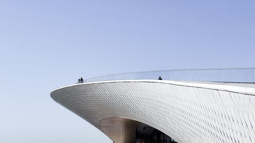 Low angle view of bridge against clear blue sky