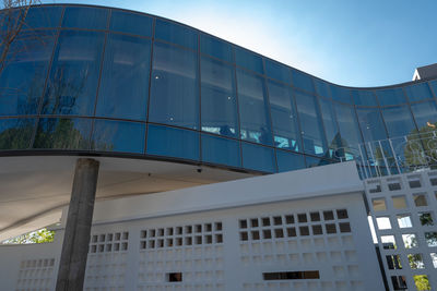 Low angle view of modern building against clear blue sky