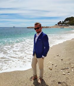 Full length of young man standing on beach