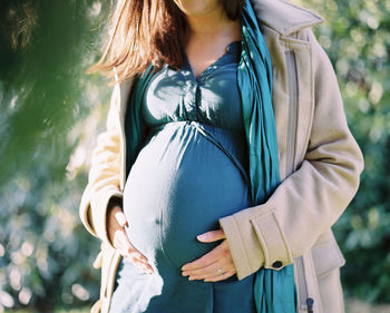 Midsection of woman with umbrella