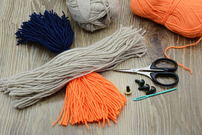 High angle view of wool and scissors on table