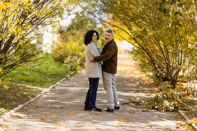 Portrait of a mature couple 50 years old in an autumn park.