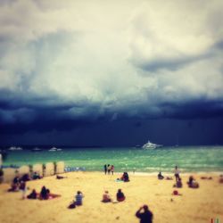 Scenic view of beach against cloudy sky