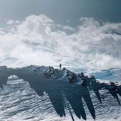 High angle view of person standing on snowcapped mountain against sky