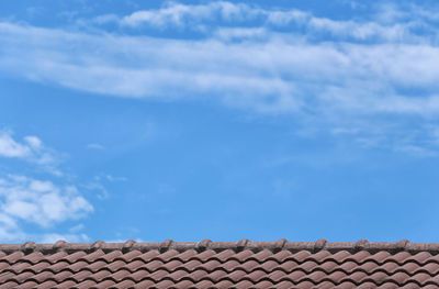 Low angle view of building roof against sky