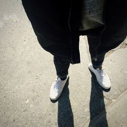 Low section of woman standing on tiled floor