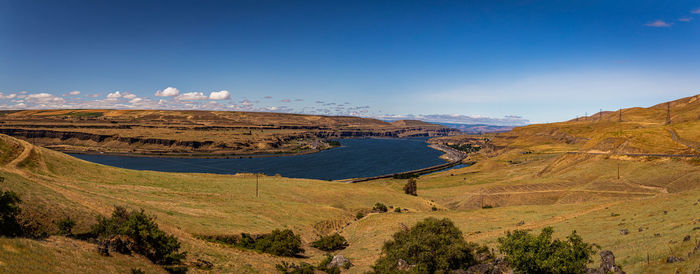 Scenic view of landscape against blue sky