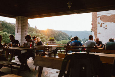 Group of people sitting on table at restaurant