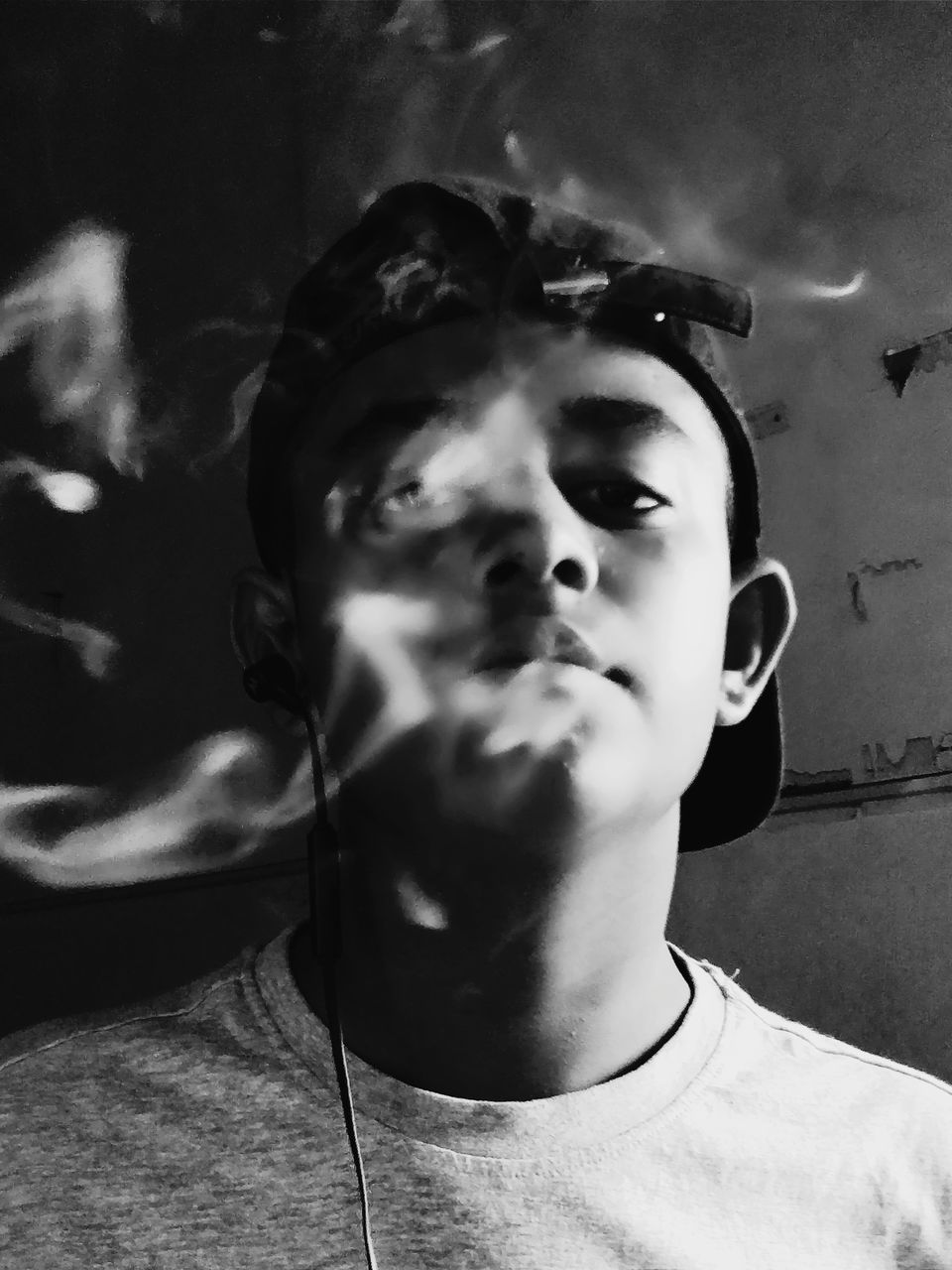 PORTRAIT OF YOUNG MAN SMOKING