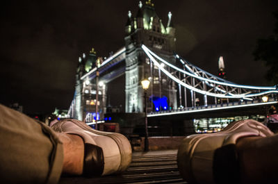Bridge over river in city at night