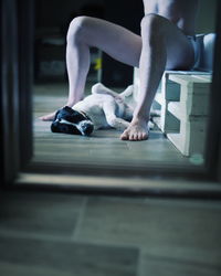 Low section of woman sitting on floor