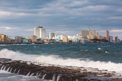 Scenic view of sea and buildings against sky