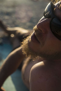 Close-up of man relaxing at beach