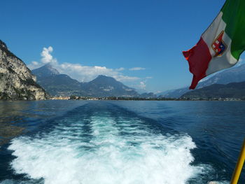 Scenic view of sea against mountains and blue sky