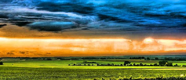 Scenic view of landscape against dramatic sky