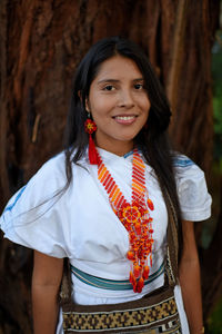 Portrait of a happy young arhuaco indigenous woman in a forest of colombia