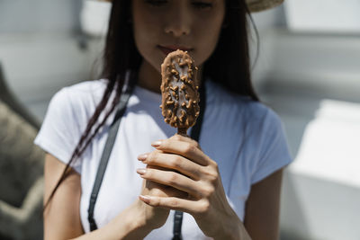 Woman holding ice cream in city